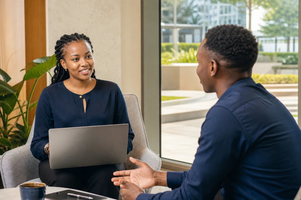 Female professionals discussing ideas and career development in a modern workplace.